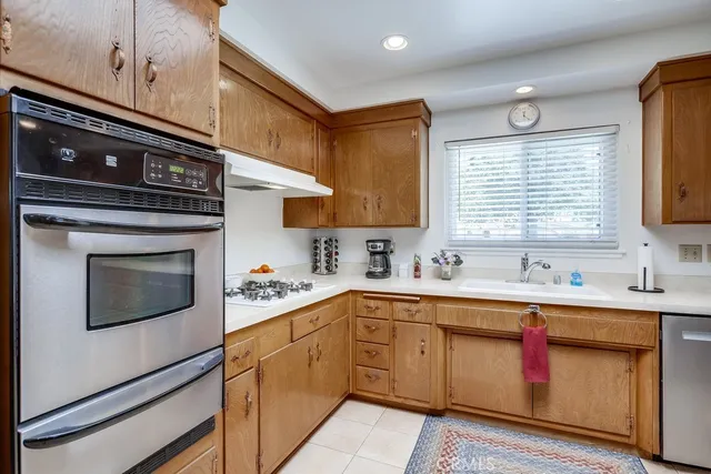 a kitchen with stainless steel appliances granite countertop a sink and cabinets