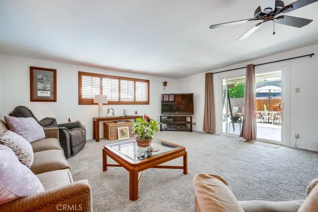 a view of a livingroom with workspace and a window