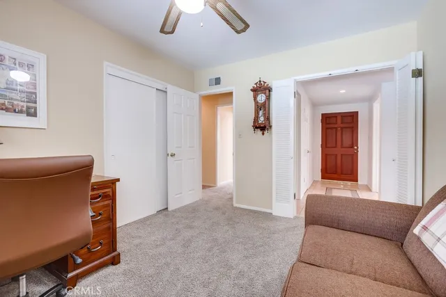 a bathroom with a granite countertop toilet sink and mirror