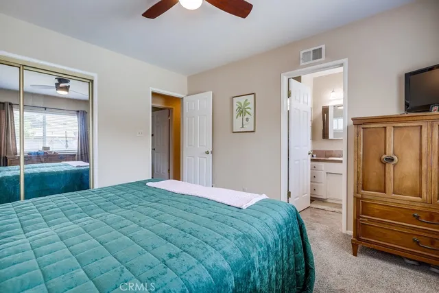 a bedroom with a large bed and a chandelier