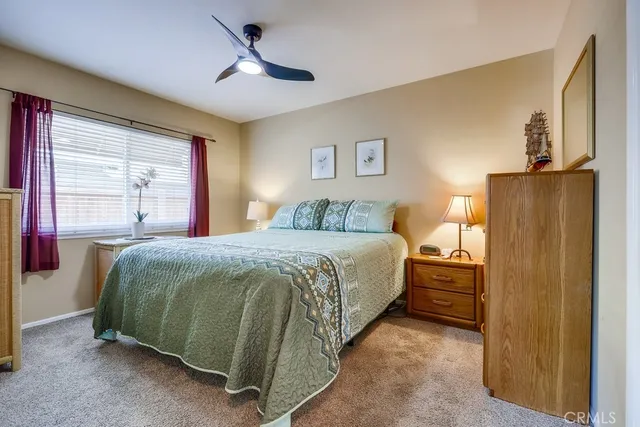 a view of a patio with a table and chairs under an umbrella