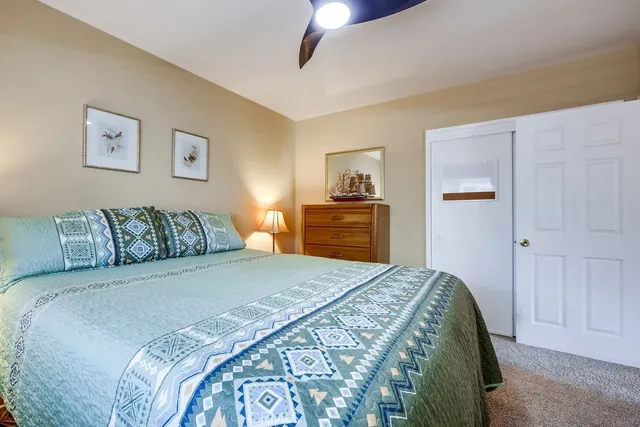 a patio with a table and chairs under an umbrella