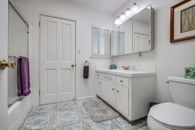 a patio area with table and chairs under an umbrella