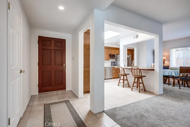 a living room with furniture a refrigerator and dining table
