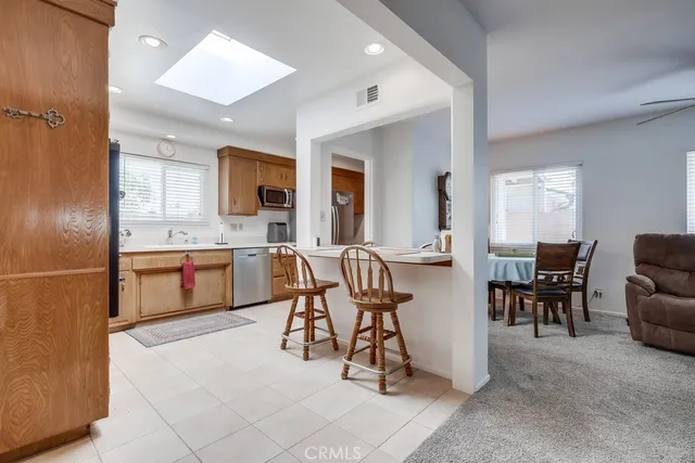 a open kitchen with stainless steel appliances granite countertop a sink and a refrigerator