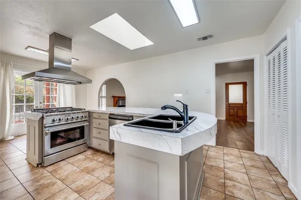 a kitchen with a stove and a sink