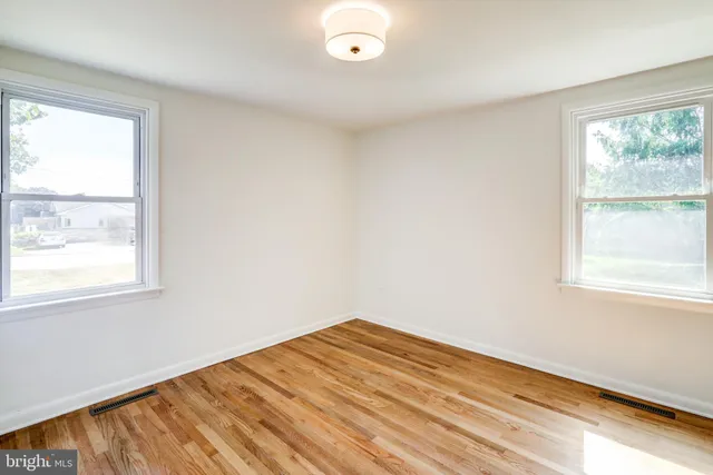 a view of hallway with wooden floor