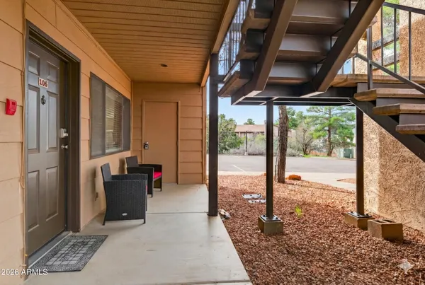 a porch with a table and chairs