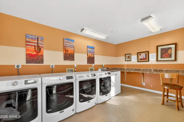 a view of a kitchen with stainless steel appliances granite countertop a stove and a refrigerator