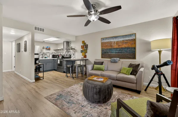 a living room with furniture and view of kitchen