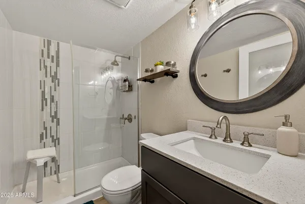 a bathroom with a sink a toilet and a mirror