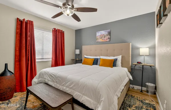 a bedroom with a bed and a chandelier