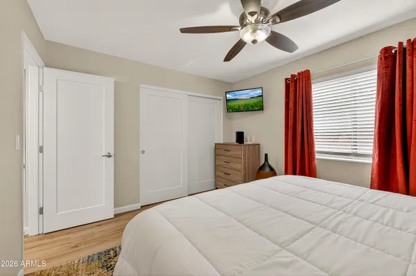 a bedroom with a bed and a chandelier