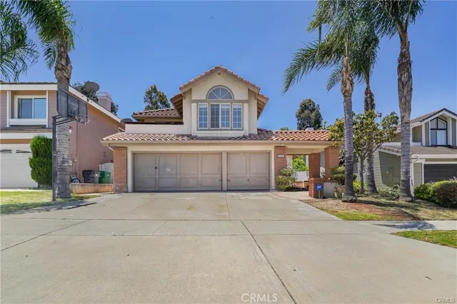 a front view of a house with a garden and a garage