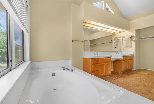 a bathroom with a sink mirror and a bath tub