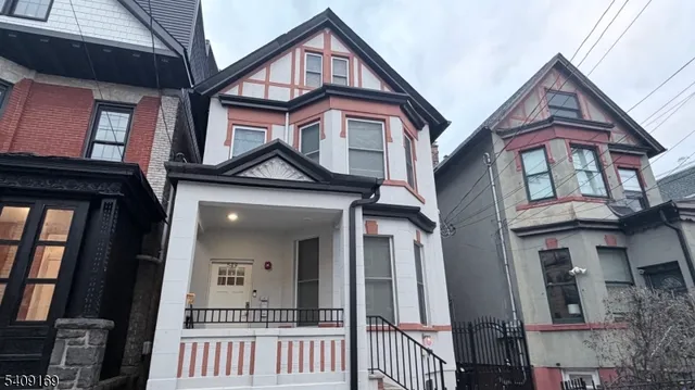 a view of a brick house with large windows