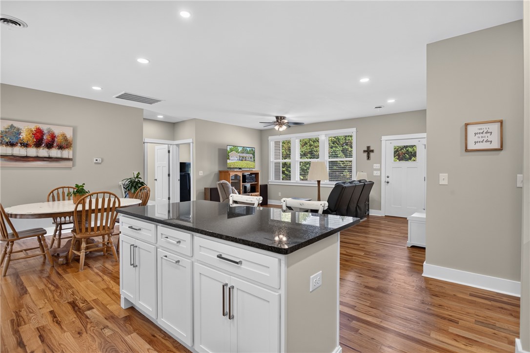 405 Pawnee Drive Walhalla, SC 29691 - Photo 36 of 36 An open floorplan seamlessly connects the kitchen to the living area, featuring rich hardwood flooring and recessed lighting.