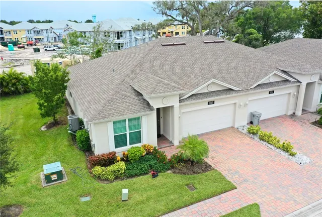 a aerial view of a house with a yard and potted plants