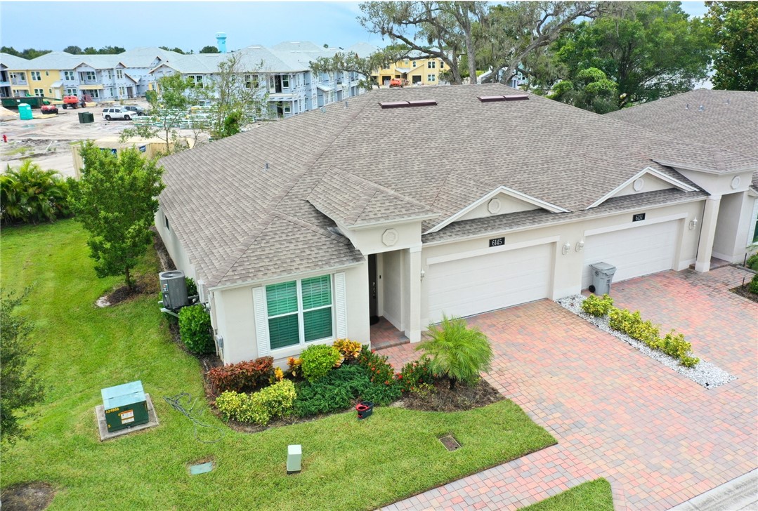 a aerial view of a house with a yard and potted plants