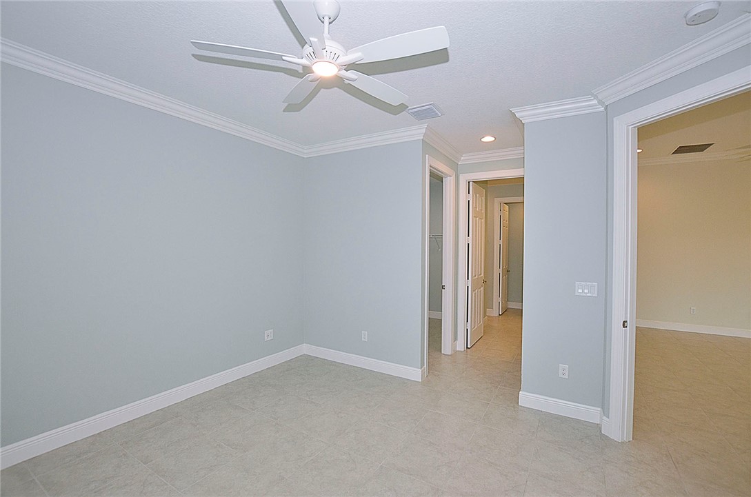 6145 Bella Rosa Lane Vero Beach, FL 32966 - Photo 15 of 36 an empty room with a ceiling fan and a window