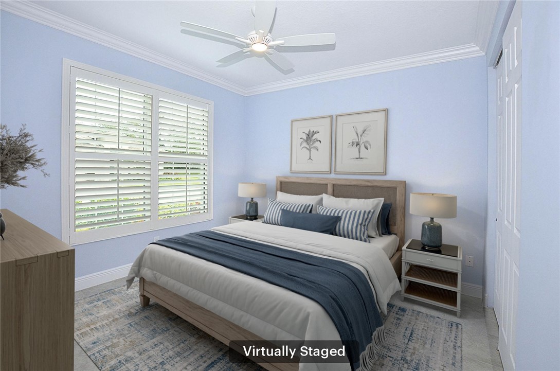 6145 Bella Rosa Lane Vero Beach, FL 32966 - Photo 20 of 36 a bedroom with a large bed and a window