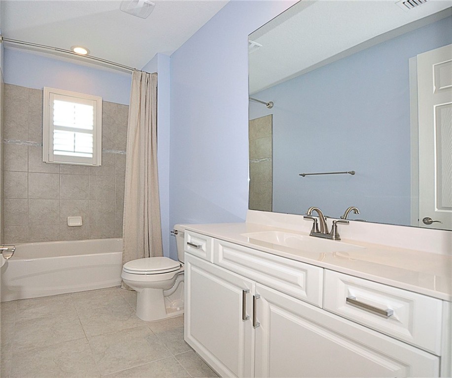 6145 Bella Rosa Lane Vero Beach, FL 32966 - Photo 22 of 36 a bathroom with a sink a toilet and a bathtub