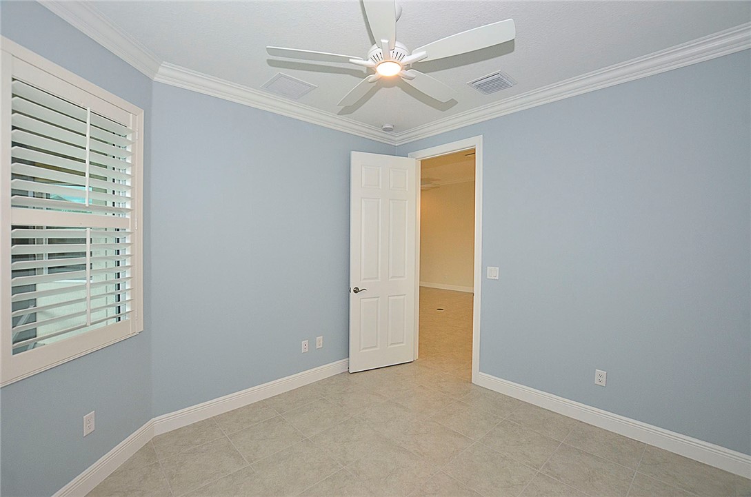6145 Bella Rosa Lane Vero Beach, FL 32966 - Photo 24 of 36 an empty room with windows and fan