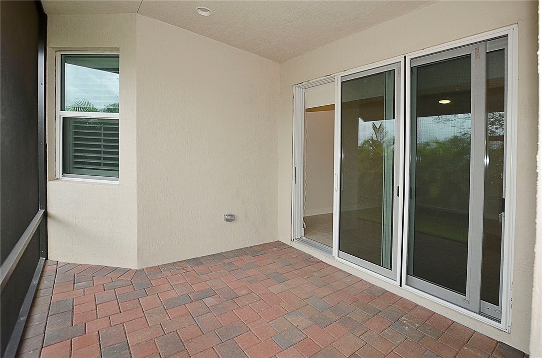 6145 Bella Rosa Lane Vero Beach, FL 32966 - Photo 27 of 36 an empty room that has a sliding door