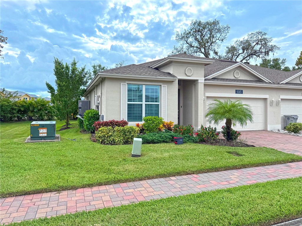 6145 Bella Rosa Lane Vero Beach, FL 32966 - Photo 3 of 36 a front view of a house with a yard