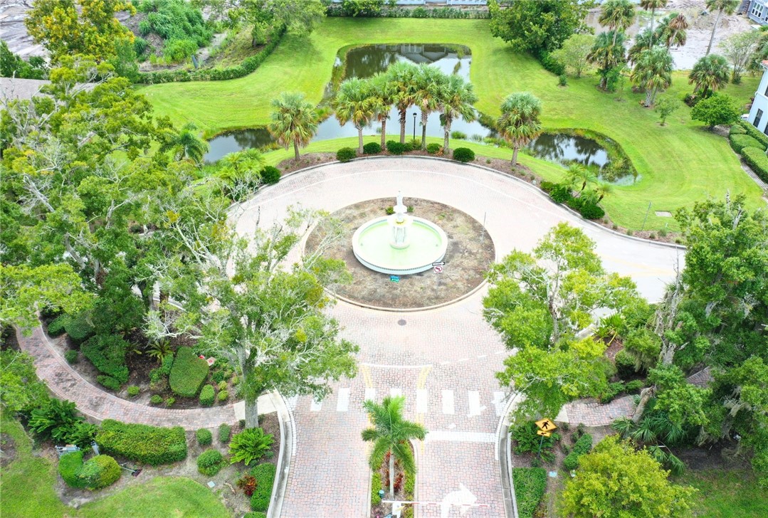 6145 Bella Rosa Lane Vero Beach, FL 32966 - Photo 34 of 36 an aerial view of a house with a garden and lake view