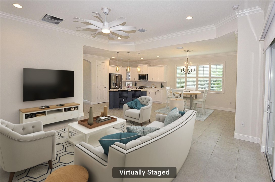 6145 Bella Rosa Lane Vero Beach, FL 32966 - Photo 7 of 36 a living room with furniture and a flat screen tv