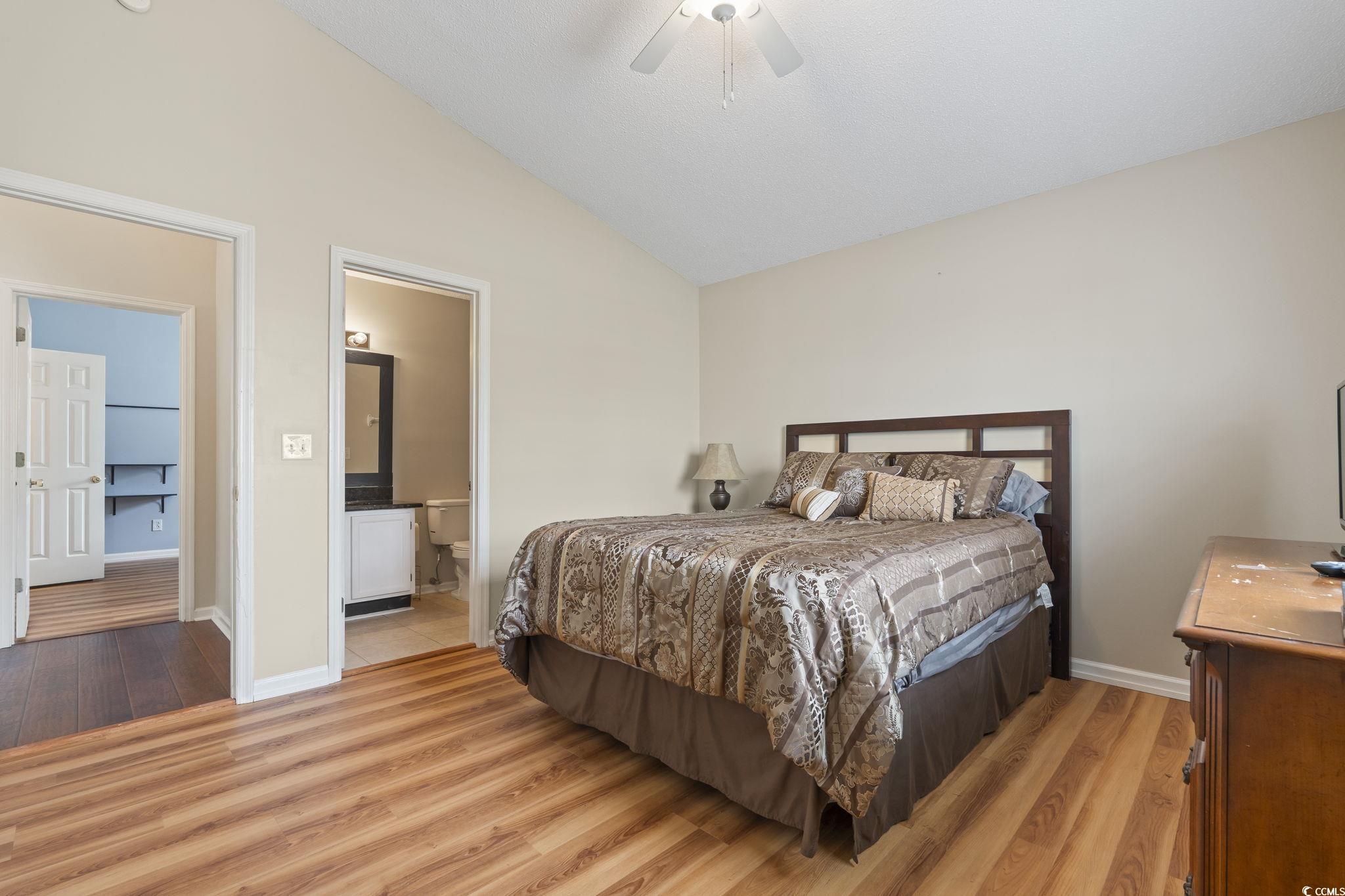 1130 Ganton Way Myrtle Beach, SC 29588 - Photo 13 of 30 Bedroom with light wood-style flooring, baseboards, connected bathroom, and lofted ceiling