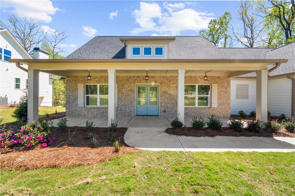 8915 Bethel Road Gainesville, GA 30506 - Photo 11 of 54 a front view of a house with a yard outdoor seating and a potted plant