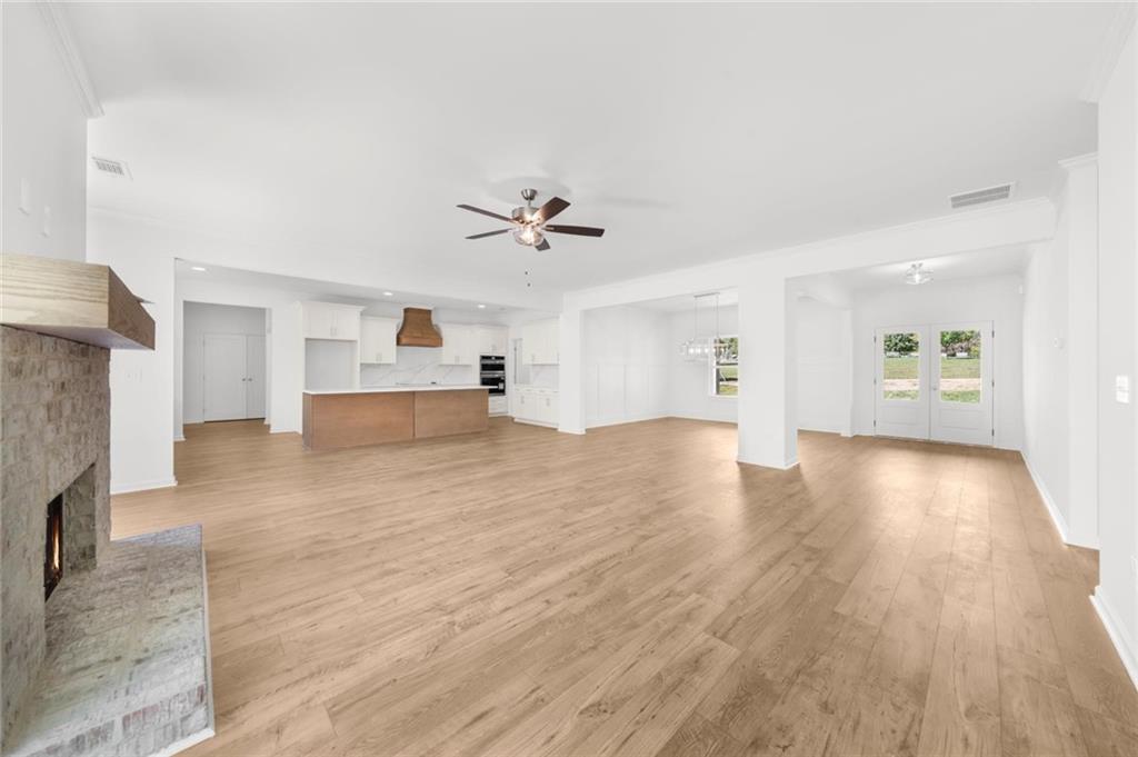 8915 Bethel Road Gainesville, GA 30506 - Photo 20 of 54 a view of empty room with wooden floor and fireplace