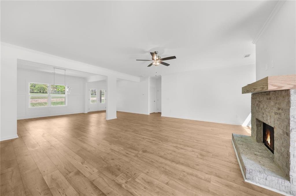8915 Bethel Road Gainesville, GA 30506 - Photo 21 of 54 a view of an empty room with a fireplace and wooden floor