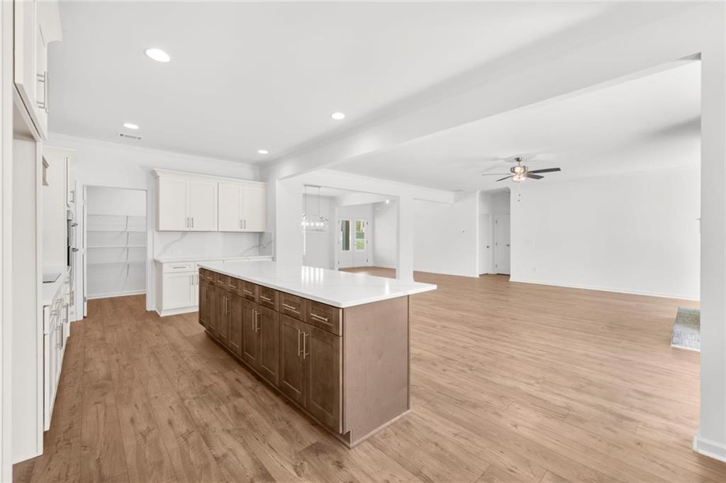 8915 Bethel Road Gainesville, GA 30506 - Photo 24 of 54 a large kitchen with a center island wooden floor and stainless steel appliances