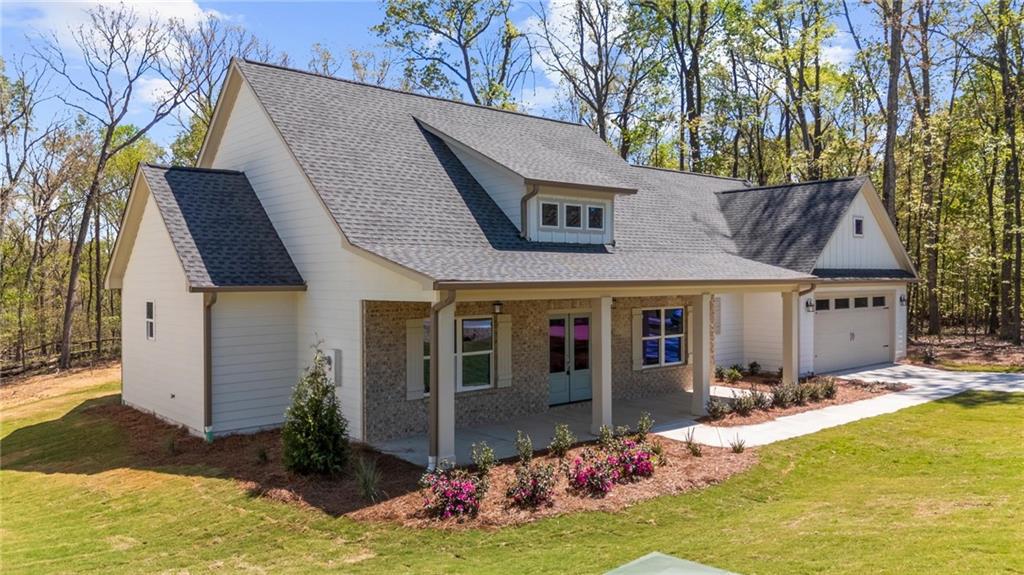 8915 Bethel Road Gainesville, GA 30506 - Photo 3 of 54 a front view of house with yard and trees in the background