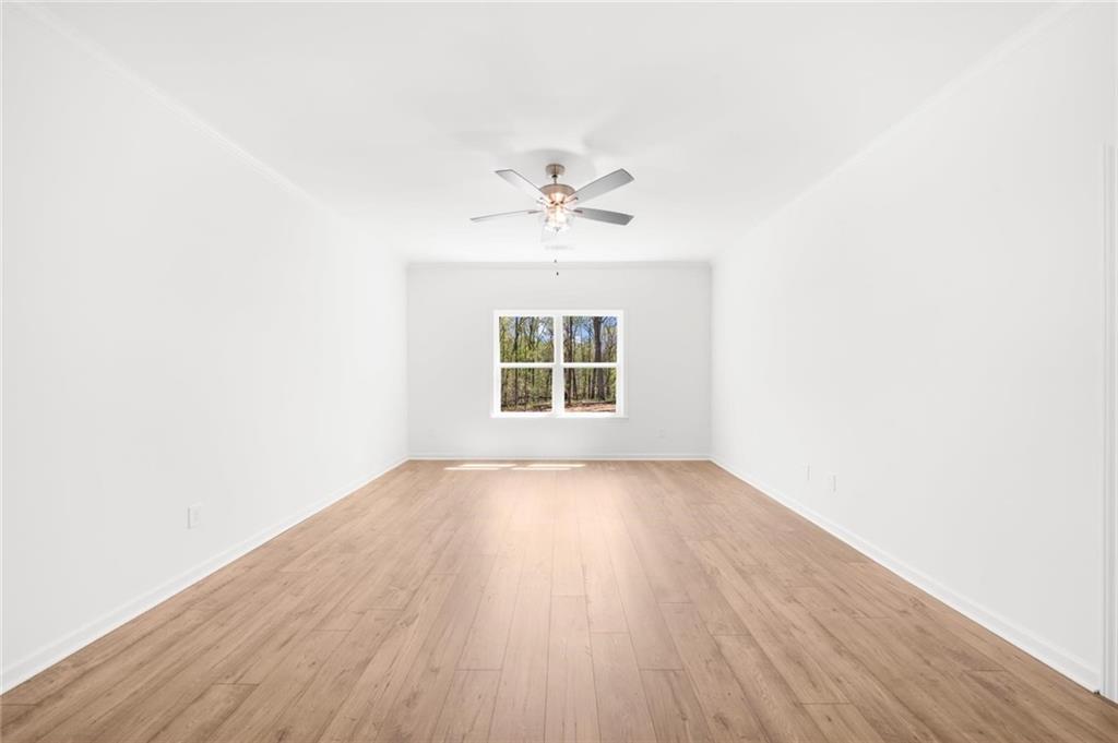 8915 Bethel Road Gainesville, GA 30506 - Photo 35 of 54 an empty room with wooden floor and windows