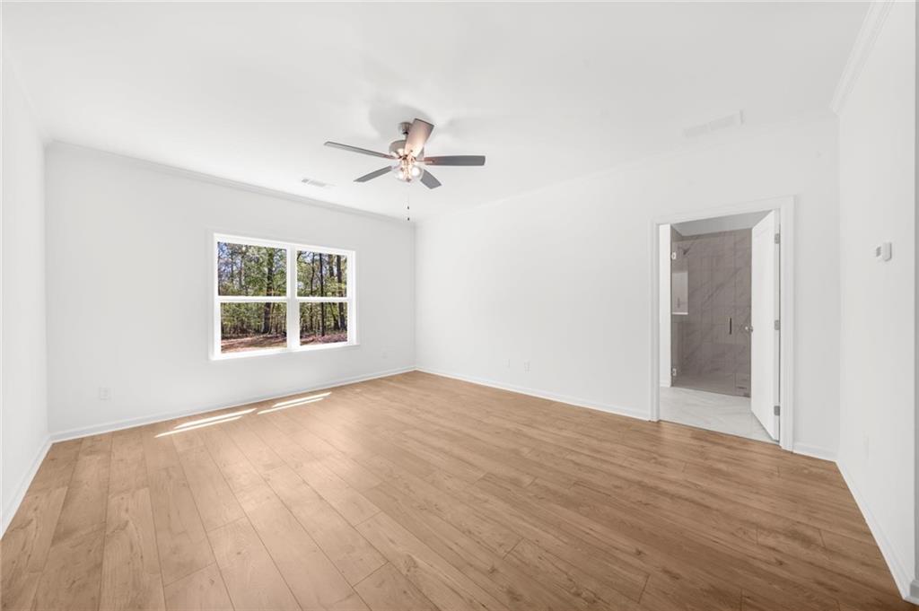 8915 Bethel Road Gainesville, GA 30506 - Photo 36 of 54 a view of an empty room with a window and wooden floor