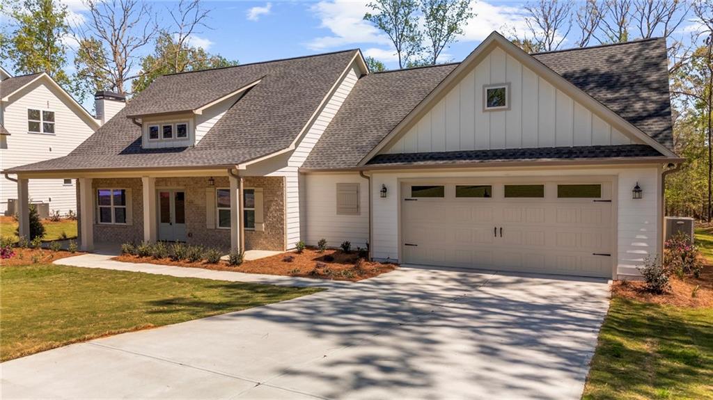 8915 Bethel Road Gainesville, GA 30506 - Photo 8 of 54 a front view of a house with a yard outdoor seating and garage