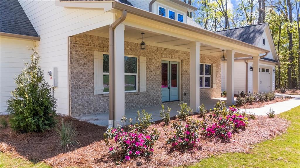 8915 Bethel Road Gainesville, GA 30506 - Photo 9 of 54 a front view of a house having flowers