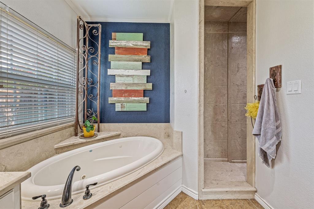 112 Blue Ribbon Lane Stephenville, TX 76401 - Photo 19 of 31 a bathroom with a tub and a sink