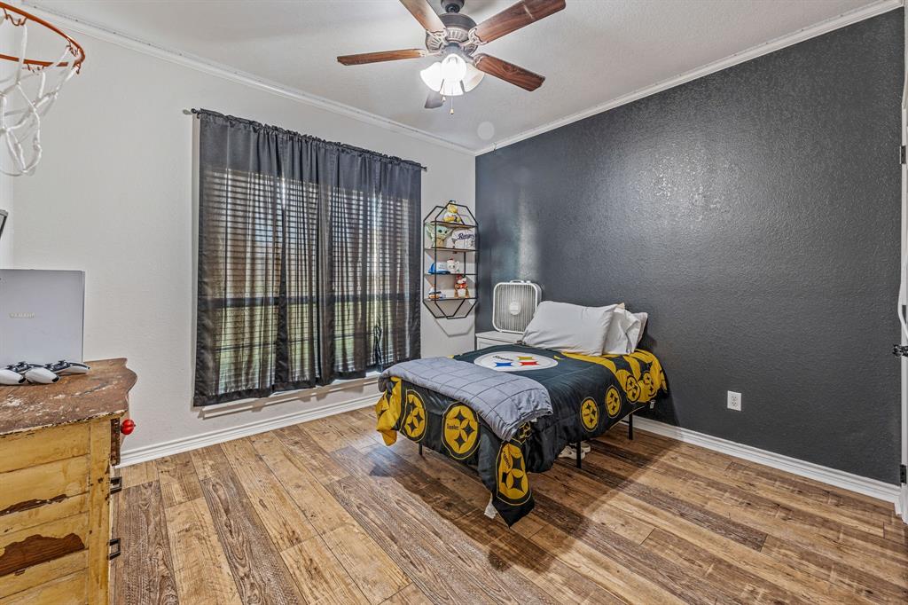 112 Blue Ribbon Lane Stephenville, TX 76401 - Photo 22 of 31 a bedroom with a bed and a window