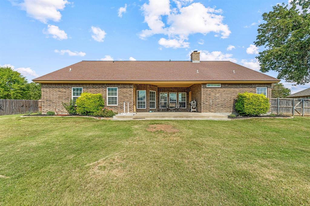 112 Blue Ribbon Lane Stephenville, TX 76401 - Photo 29 of 31 a front view of a house with a garden