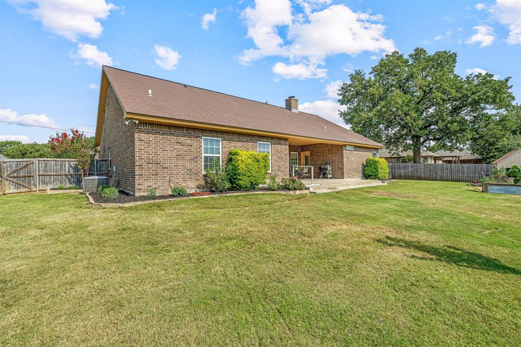 112 Blue Ribbon Lane Stephenville, TX 76401 - Photo 30 of 31 a view of a house with a backyard and a patio