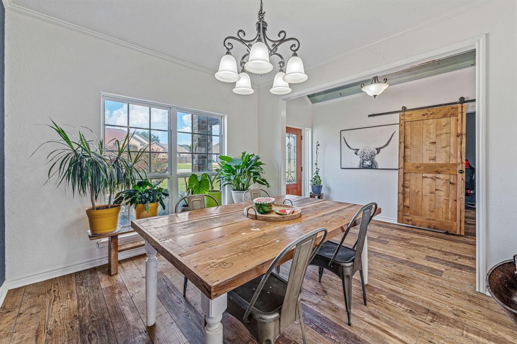 112 Blue Ribbon Lane Stephenville, TX 76401 - Photo 5 of 31 a view of a dining room with furniture and wooden floor