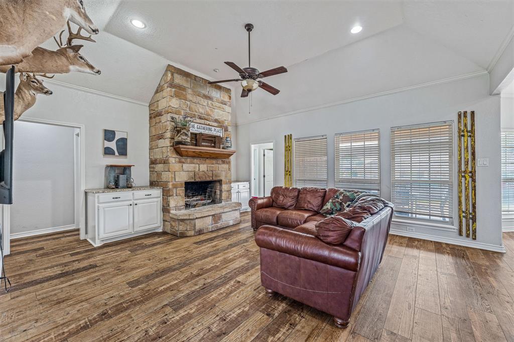 112 Blue Ribbon Lane Stephenville, TX 76401 - Photo 8 of 31 a living room with furniture and a fireplace