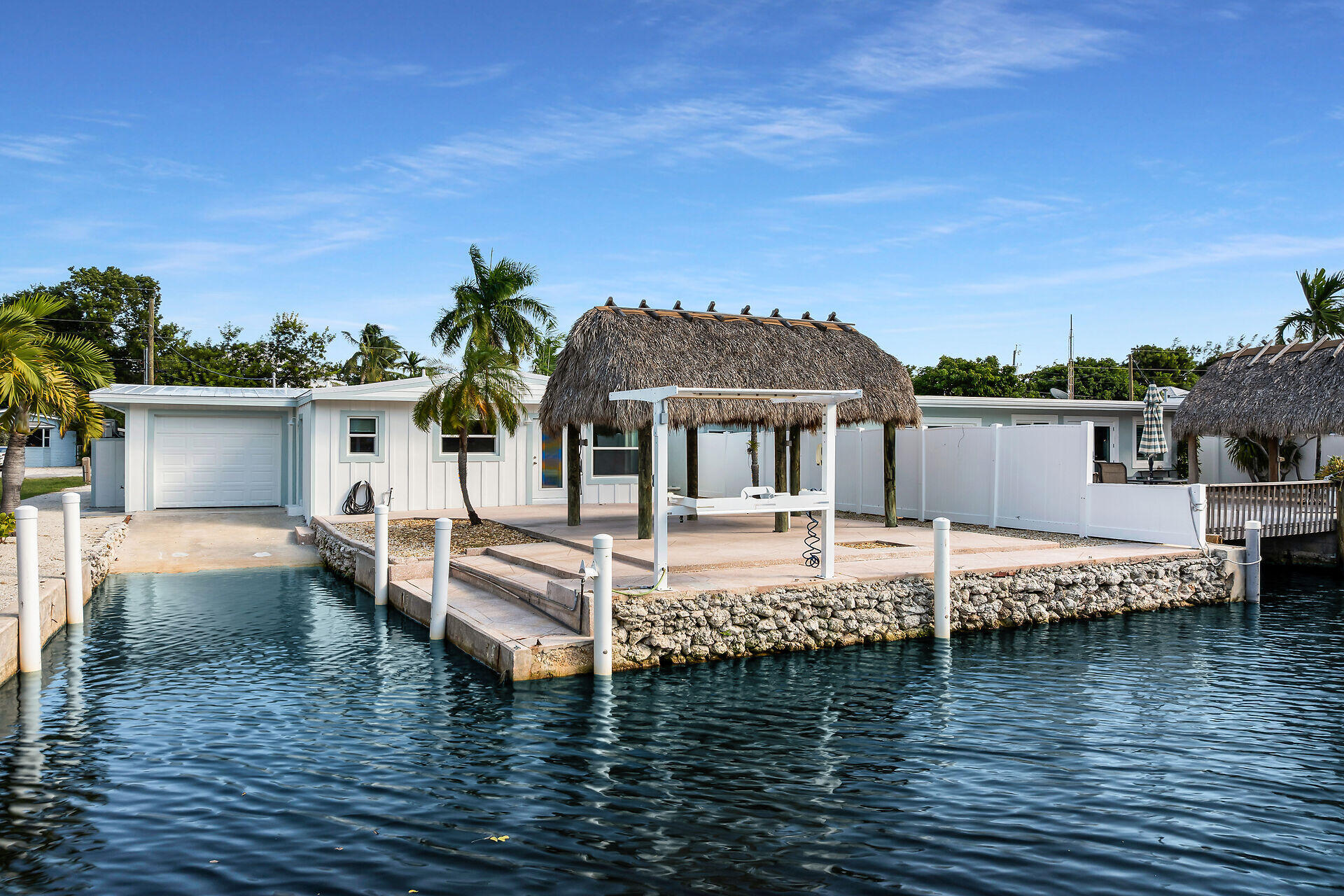 a view of a house with pool and ocean view