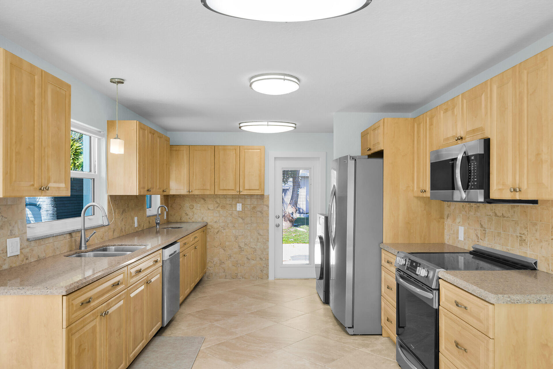 251 Azalea Street Tavernier, FL 33070 - Photo 11 of 58 a kitchen with a sink stove and refrigerator