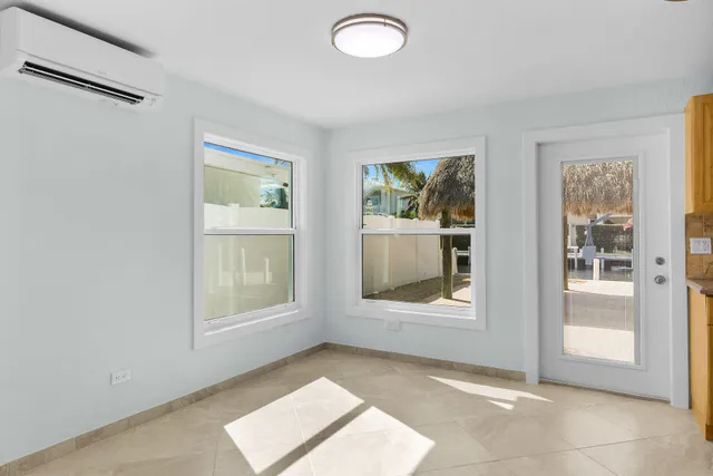 an empty room with a empty space and windows